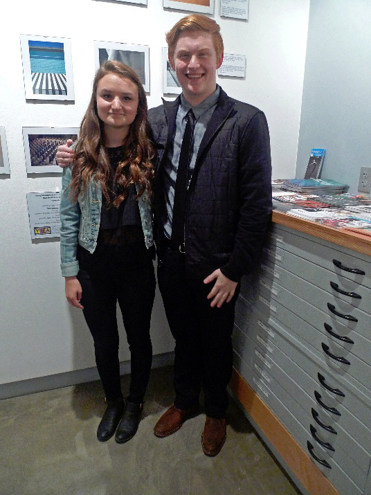 Student Photographers Elise F. and Tate M. stand proudly in front of their work.