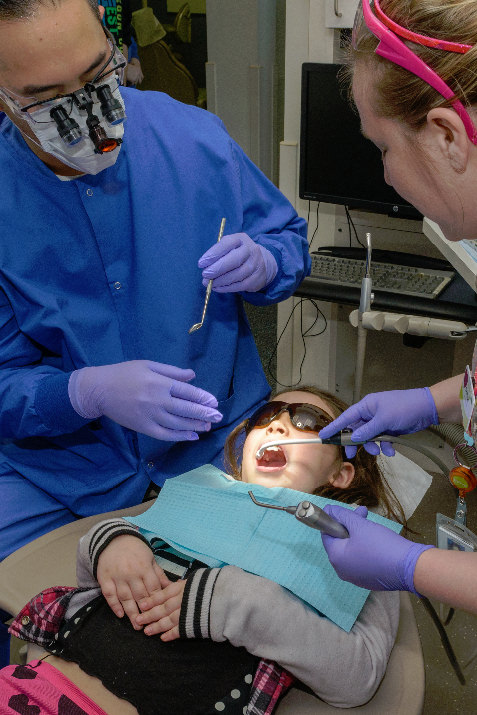 Kaiser Permanente dentist Cyrus Lee and dental assistant Crystal Schnacky provided 7-year-old August Ebalaroza with free dental care as part of the Give Kids a Smile clinics that took place throughout Oregon and Southwest Washington on Feb. 7. Credit: Andie Petkus Photography  