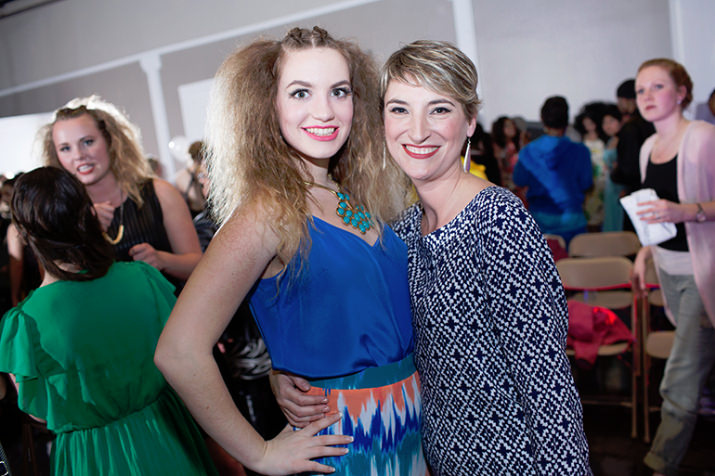 Caity, an Amy Vining Photography senior model wearing Mabel and Zora, poses with Amy Vining after the show.