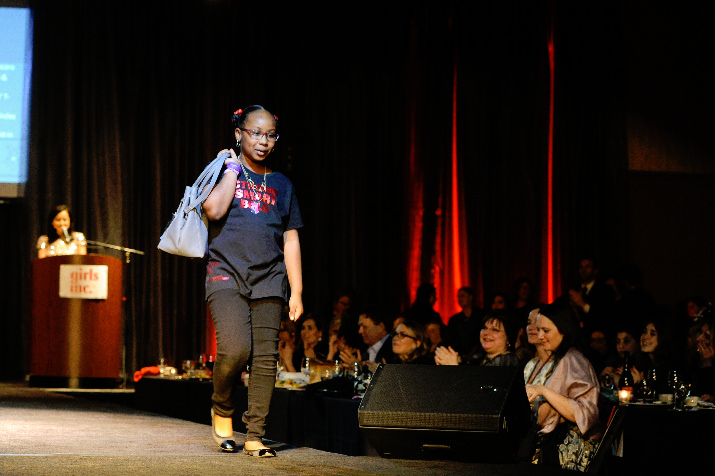 Girls Inc. girl, Alexis, shows off the purse designed by Christina Castillo Designs for Purse-o-nality Aneshka Dickson. 