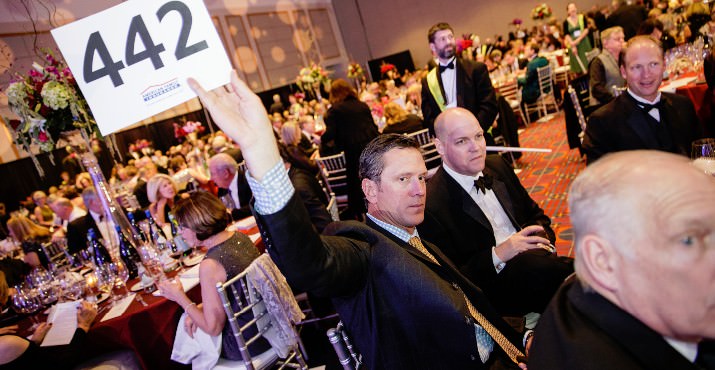 Former New England Patriots Quarterback and Proprietor of Doubleback Winery, Drew Bledsoe, bids during the live auction