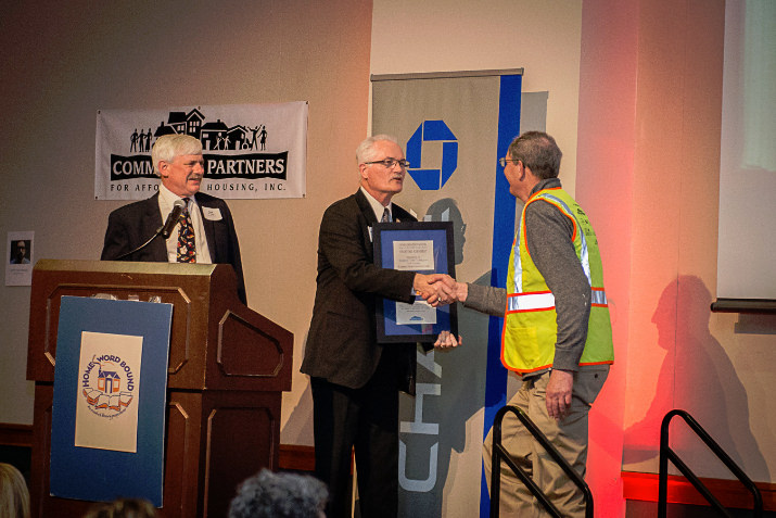 CPAH’s Friend of Affordable Housing Award 2015 winner, Washington County Commissioner Dick Schouten (right), receives the award from 2015 recipient Metro Councilor Craig Dirksen, as CPAH Board Treasurer Doug Plambeck (left) looks on, at CPAH's HomeWord Bound 2015, April 10, at the Oregon Zoo. Photo by Angela Bohlke.