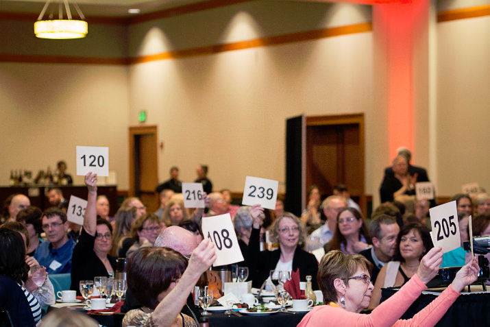 Generous CPAH supporters raised their paddles for a record amount at “HomeWord Bound: An Event of Literary Proportions,” the 17th annual fundraiser for Community Partners for Affordable Housing on April 10 at the Oregon Zoo. Photo by Angela Bohlke.