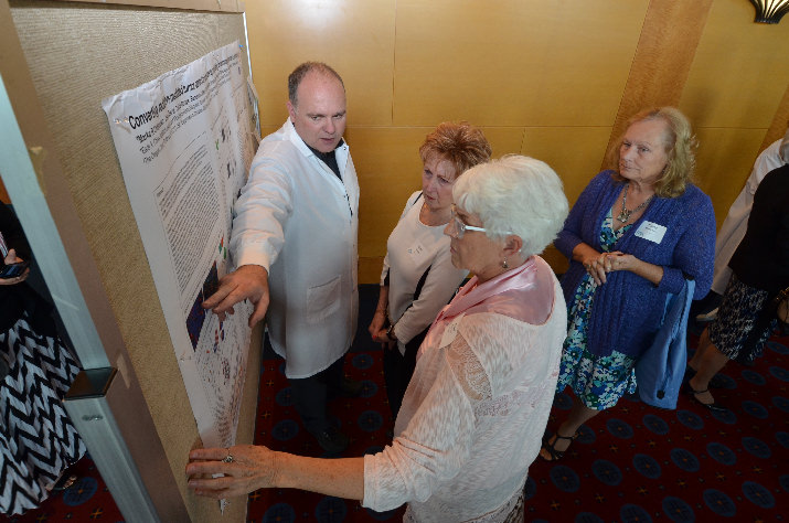 Providence Cancer Center researcher Michael Gough, Ph.D., explains immunotherapy studies to attendees at Providence’s 17th annual Creating Hope for Cancer Patients Luncheon. Prior to the program and lunch, the 630 attendees visited with a host of scientists describing the latest work at Providence Cancer Center. The cancer center focuses on immunotherapy – the ability of the body to heal itself.