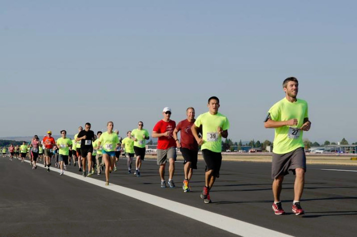 Take part in the 2nd Annual Run on the Runway 5K and experience the unique opportunity to actually run on the Hillsboro Airport runways. The 5K course will wind you around the airport runways and taxiways and send you out to places only planes can go!  Come out, join the fun, and support the Hillsboro Schools Foundation. The 2nd annual event is open to just 500 runners aged 14 and older and is open to individuals and groups. The run will be timed and awards will be given for the following divisions: TBA Day and Time: Sunday, July 19, 2015 Entry to airport run starting area: 8:00am Start of Race: 9:00am* Registration packet and fees: The Run on the Runway 5K is open to 500 runners aged 14 and older. Due to Air Show restrictions, the run MUST finish by 10:30am. Please do not register if you cannot complete the 5K in one hour. $45 includes a chipped run bib, free parking, one general admission ticket to the Air Show and official run shirt. $30 includes chipped run bib, free parking and official run shirt. Groups should contact the Air Show office at 503-629-0706.
