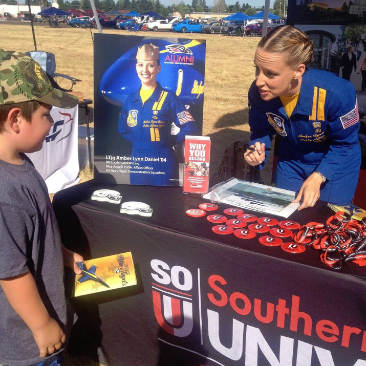 Public Affairs Officer, Lt. Amber Lynn Daniel, @SouthernOregonUniversityAlumniAssociation is signing autographs at the University’s booth