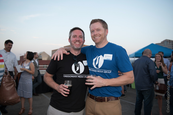 John McPhee and Kevin Bekker from event sponsor, Oregonian Media Group, enjoy some great brews provided by the Growler Guys during the SEMpdx Rooftop Party. 