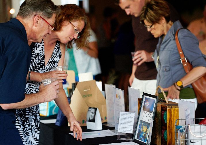 PYB donors Ben and Sue Donora peruse the silent auction table before the program begins 