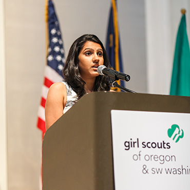 Girl Scout Gold Award recipient Varsha Kalavar addresses a crowd of more than 460 alumnae and community supporters.