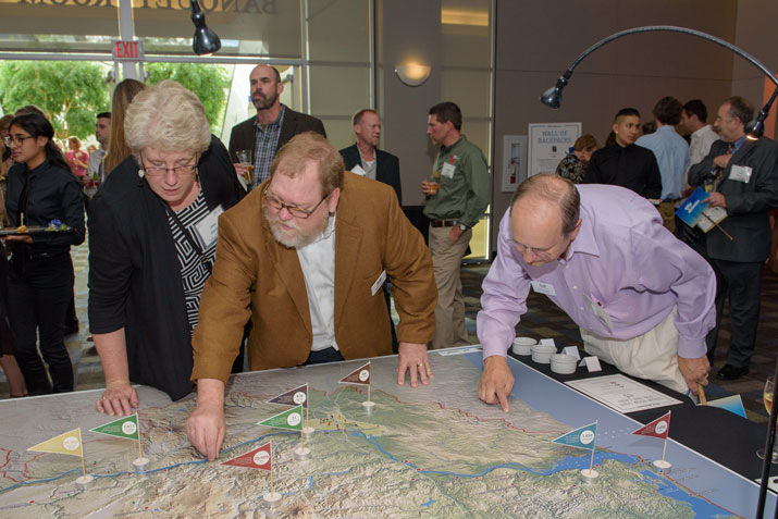 o Amy Gredler and board members Marc Smiley and Jim Thayer explore a map of the Columbia Land Trust service region, pinning their favorite locations.