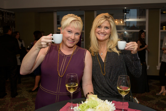 Stacy Dalgarno (left) and Annemie Willaims (right) of 100 Women Who Care Portland cheers to Raphael House during cocktail hour.