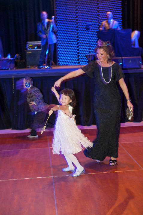 Wish kid Lexi, 4, lights up the dance floor as she gives her best twirl for KATU anchor Debora Knapp, who emceed the event.
