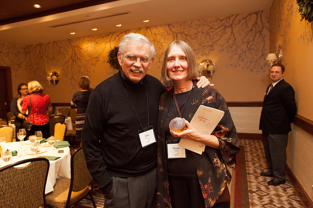 John and Susan Saling hold a glass acorn designating the late Sally Ann Brown's induction into the Pacific University President's Circle
