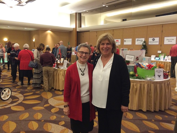Judy Crook and Lindy Fredricks pose briefly for the camera before starting their bids on all the wonderful silent auction items.