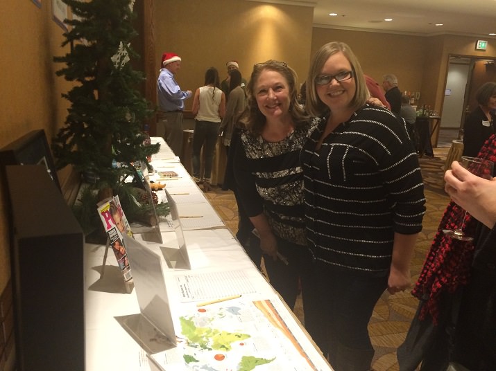 Judy Hardy and Mikayla Patrick make sure Judy places the winning bid on the Log Home vacation stay.