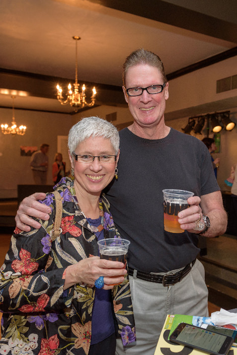 Judith Huck, owner of Classique Floors in Portland and her husband Joe Huck, had fun bidding on silent auction items on their mobile phones at the Human Solutions auction.