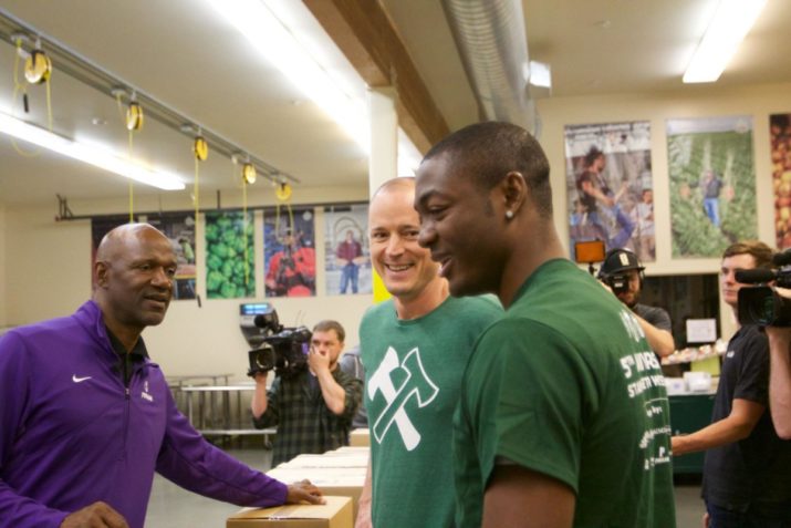 une 9, 2016; Portland, OR, USA; Timbers Owner & CEO Merritt Paulson talks with former Portland Trail Blazer and Univ. of Portland coach Terry Porter and forward Fanendo Adi at the Oregon Food Bank. Photo: 