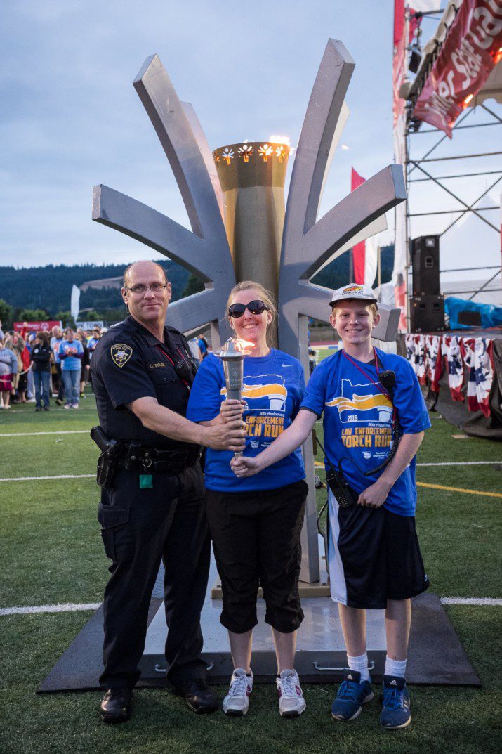 The Flame of Hope is delivered to the opening ceremony at the Newberg High School track.