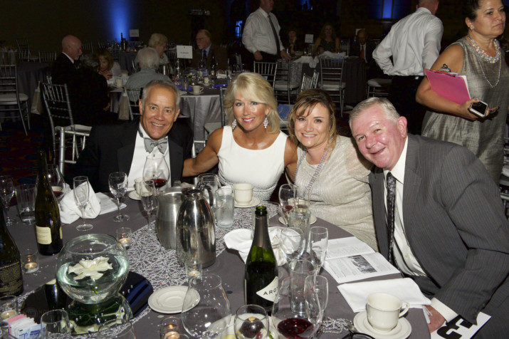 Jan & Eric Hoffman (left), supporters of this year's Hearts & Hands Gala enjoy the evening alongside Hoffman Construction Company guests.