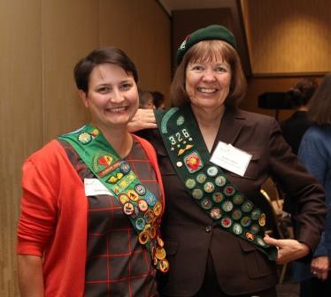 Girl Scout Alumni Robyn Shuey and GSOSW Board Member Barbara Gibbs proudly display their uniform sash.