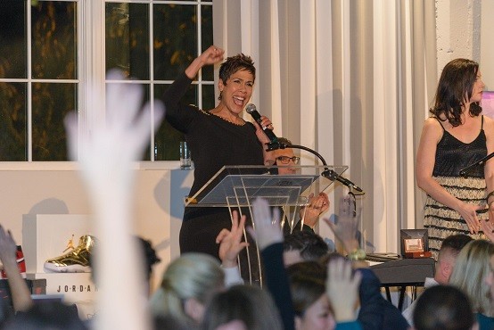 Emcee Brenda Braxton of KGW-TV gets caught up in the excitement of the live auction.