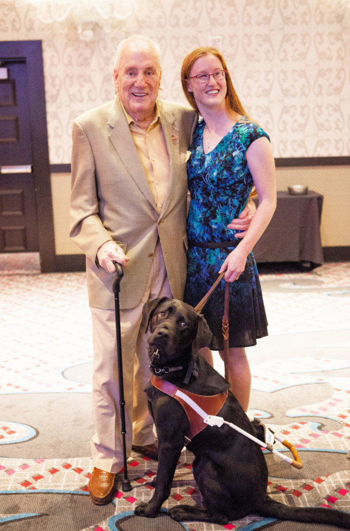 Honoree Howard Hedinger with keynote speaker Kathryn Marksen-Simonson and her guide dog, Nabisco.
