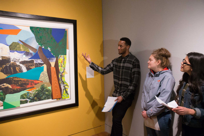 Evan Turner discusses a work of art with a student.