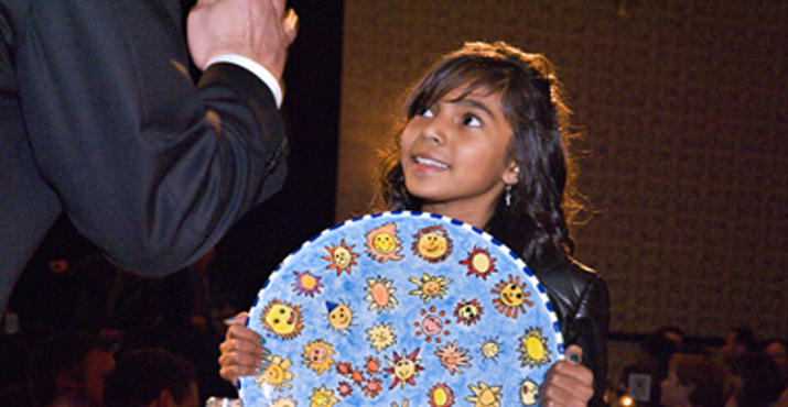 Alder Elementary Dreamer Abril Sierra presenting one of the live auction Dreamer Platters