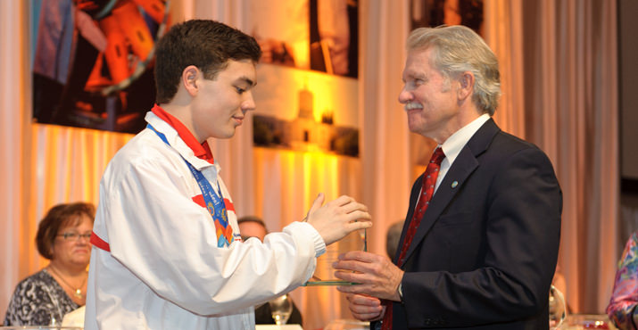 Special Olympics Oregon and World Games athlete, Mason Coad, receives his Shriver Greatness Award from Governor Kitzhaber.
