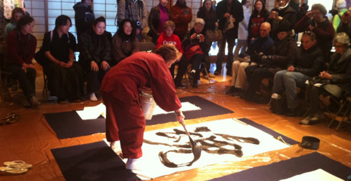 Master Calligrapher Sekko Daigo gives a demonstration of writing calligraphy in brush and ink.