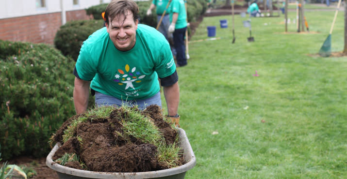 Comcast employee Dale George fills up his barrow at Centennial Middle School. Photo by Scott Cloud.