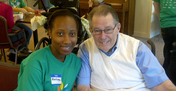 Comcast guest volunteer Martinque Willis visits with a resident at the Rose Villa Senior Living Center. Photo by Jeffery McKizzie.