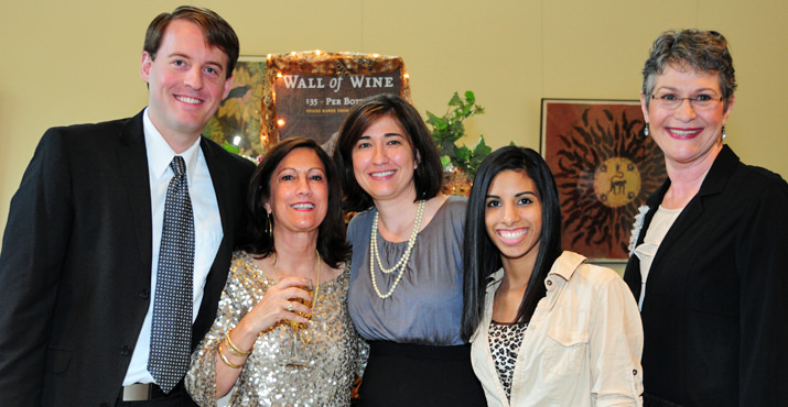 The Carleton Family, enjoys the Wall of Wine and festivities of the evening.
