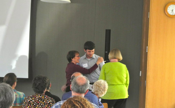 Carol Levine and Sarah Smith hug RVP Client Joe Buck after a heartfelt speech.