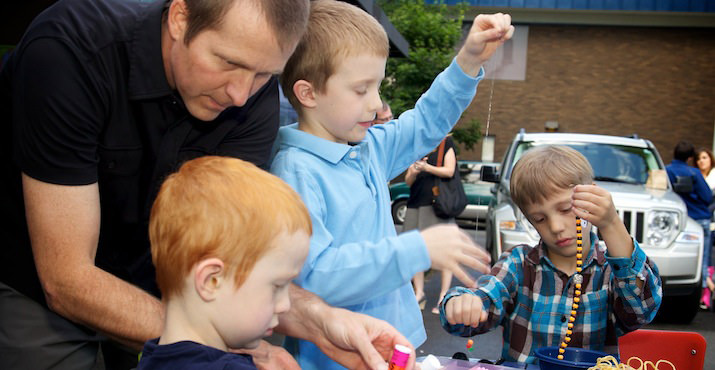 John McCalla guided three children through the final phases of a beading project.