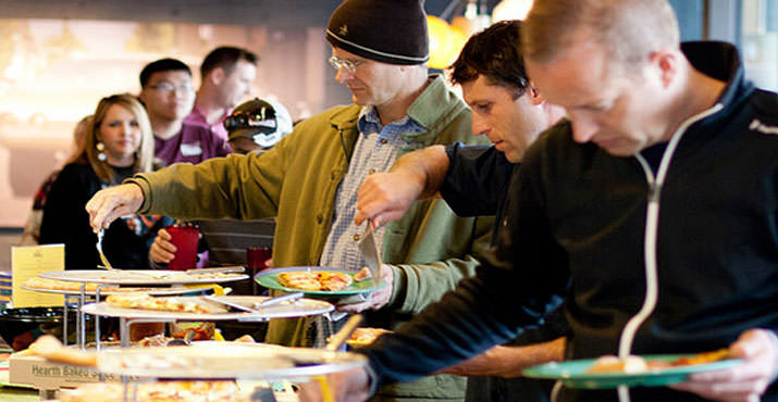 Party guests enjoying Mellow Mushroom pizza and salads!