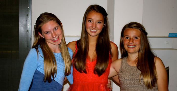 Elyse King-Guffey, Mira Petrillo and Lily Everett volunteer at the front door to help greet the guests.