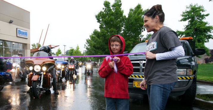 7-year old cancer survivor, Austin, cuts the ribbon to officially start the ride
