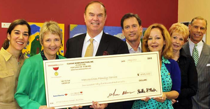 Pictured (from right to left): George Hosfield, CWA Board Member; Karen Hinsdale, CWA Board Member; Eva Kripalani, MFS Board Vice Chair; Jim Fitzhenry, CWA Board Member; Keith Barnes, CWA Board Member; Krista Larson, MFS Executive Director; and Heather Martin, CWA Executive Director display the donation presented to Metropolitan Family Services from the Classic Wines Auction.