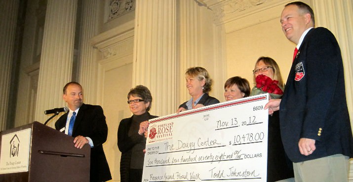 Newly elected Portland Rose Festival Foundation President Todd Johnston was joined on stage by Festival CEO Jeff Curtis and Grand Floral Walk Chair Liza McQuade to present the donation to Donna Schuurman (Executive Director) Peggy Maguire (Vice Chair of Board) and Diane Kinkade (Chair of Board) accepting the check on behalf of The Dougy Center!