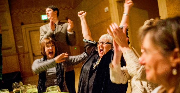 Beverly Young celebrates wildly after winning an exhilarating live auction bidding war to claim a surprise behind-the-scenes auction package for the hit NBC television series, Grimm.
