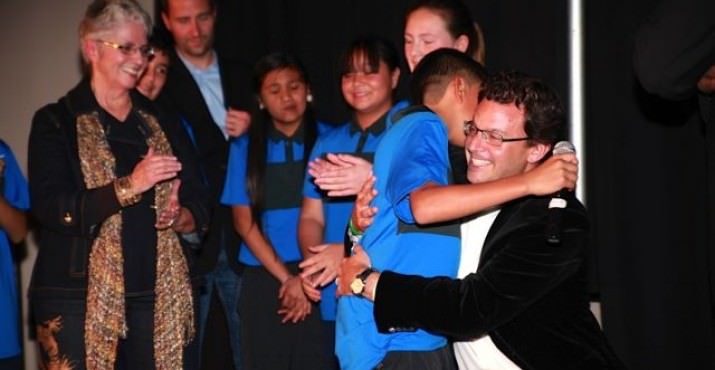 > Matt Felton receives a big thank you hug from a scholar athlete in the