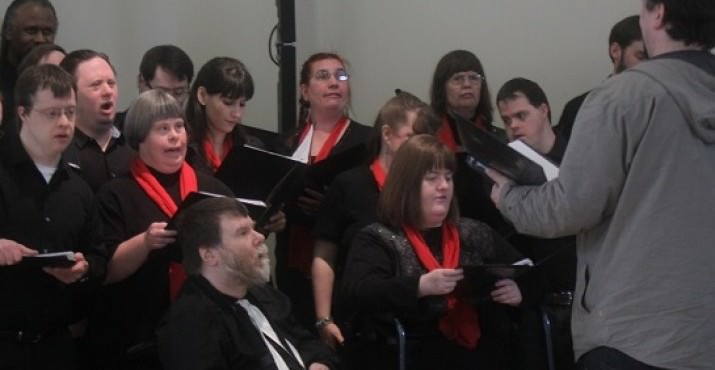 The singers of the Voices Unlimited choir perform in the Community Center's "Great Room".
