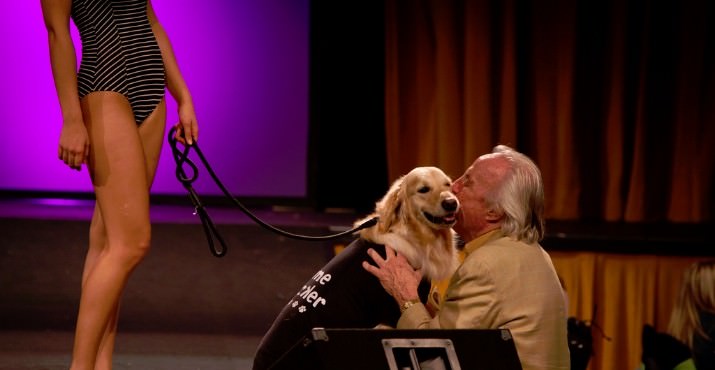 DoveLewis supporter Howard Hedinger hugs his dog Hero on the runway during the Boutiques Unleashed fashion show.