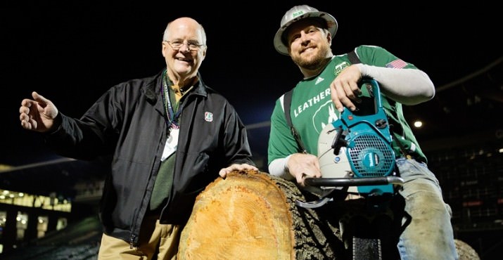 Doug Cushing smiles big for a picture with Timber Joey at the log.