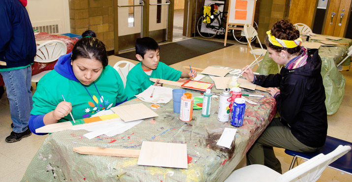 Community volunteer and Comcast Leaders and Achievers scholarship recipient Jennifer Pedro volunteers for a painting project at Native American Youth & Family Association which runs her high school, the NAYA Early College Academy. Photo by Aaron Hockley.
