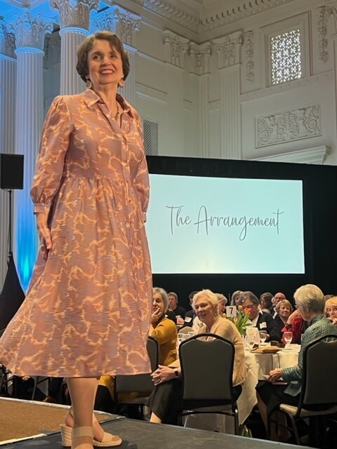 Peggy Albertine, Operation School Bell chair, models a dress and accessories from the Arrangement