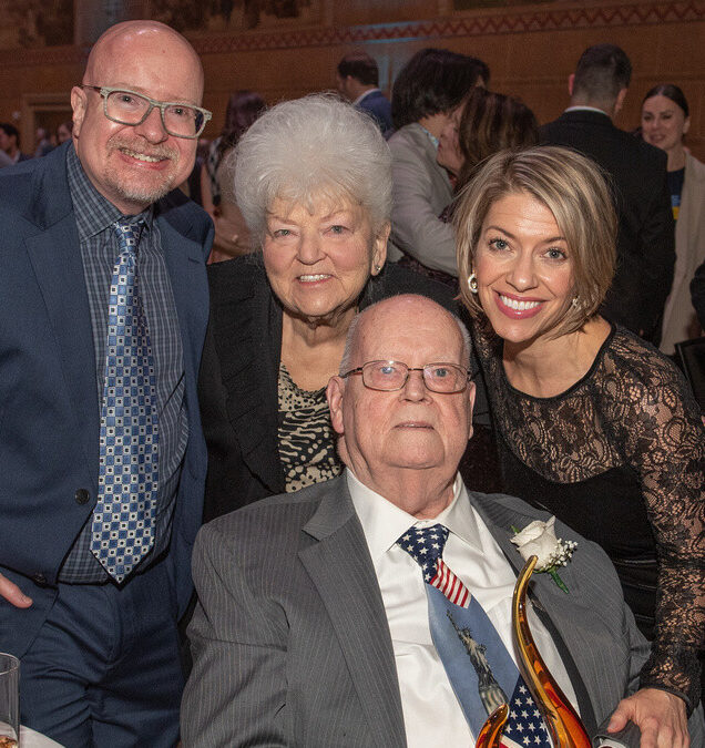 Real estate developer and philanthropist Joe Weston, seated, holds the Catholic Charities Single Candle Award April 21 backed by his family: son Joe, former wife Marilyn and daughter Tiffany. (Andie Petkus/Catholic Charities)